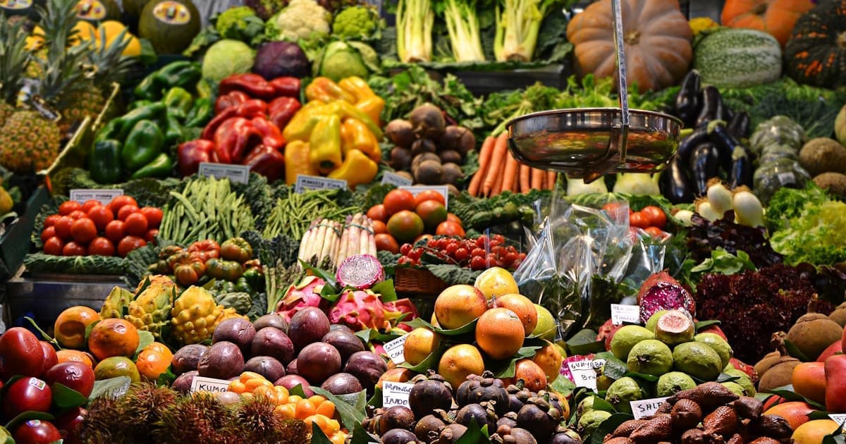 A colorful produce market filled with vegetables and fruit